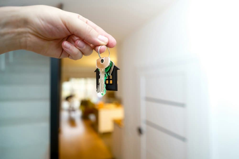 Real estate agent handing over house keys