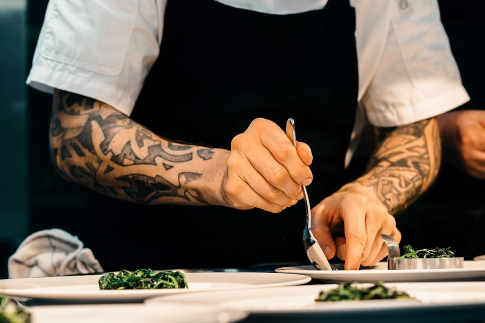 Chef plating food in a professional kitchen
